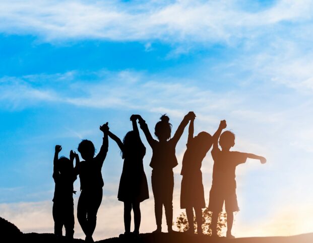 Silhouette of children holding hands