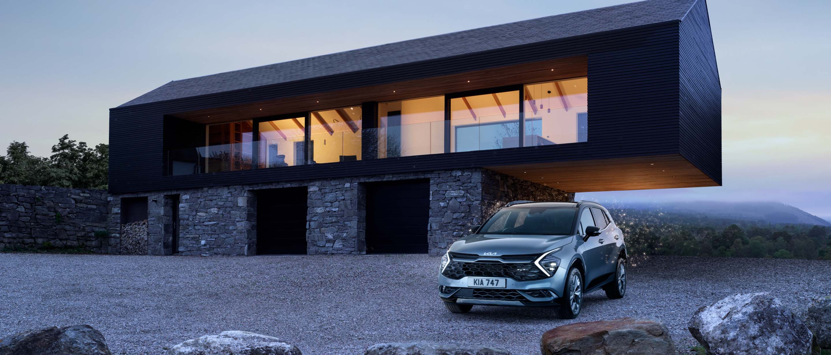 Kia Sportage in front of a modern high design house