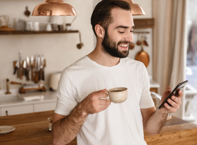 Man drinking coffee and checking his phone