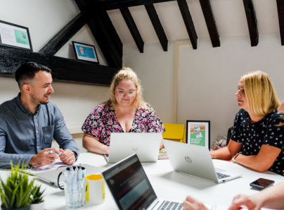 Spark team working around a table together