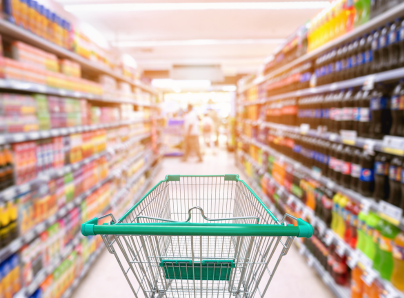 Empty shopping trolley in supermarket aisle