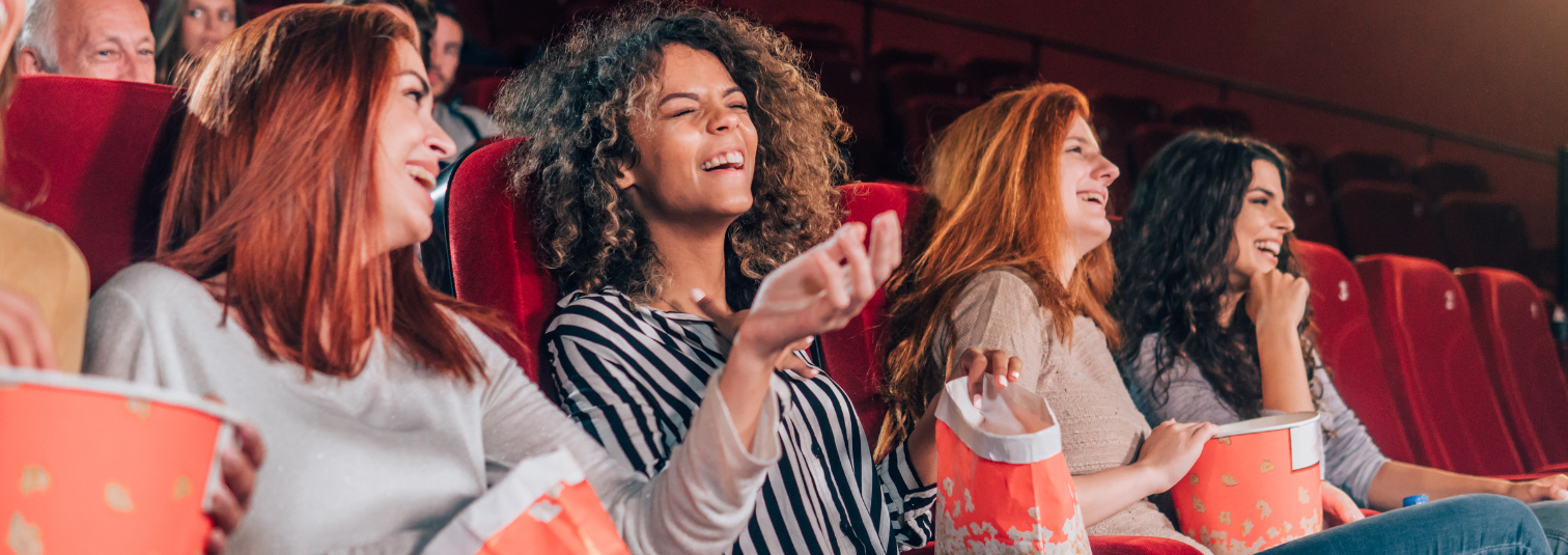 Group of young women laughing in the cinema