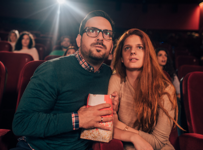 Man and woman with serious faces in the cinema