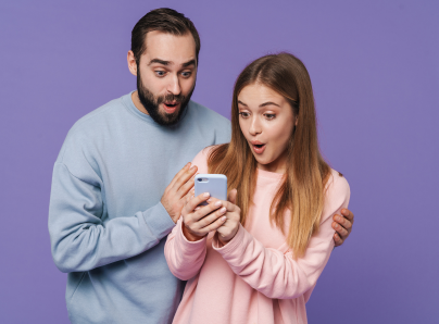 Young couple look excited with mobile phone